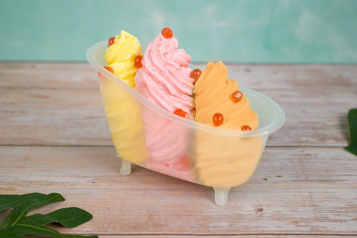 The Dole Whip Bathtub Sundae at Typhoon Lagoon, a large plant-based sundae of pineapple, strawberry, and orange Dole Whip