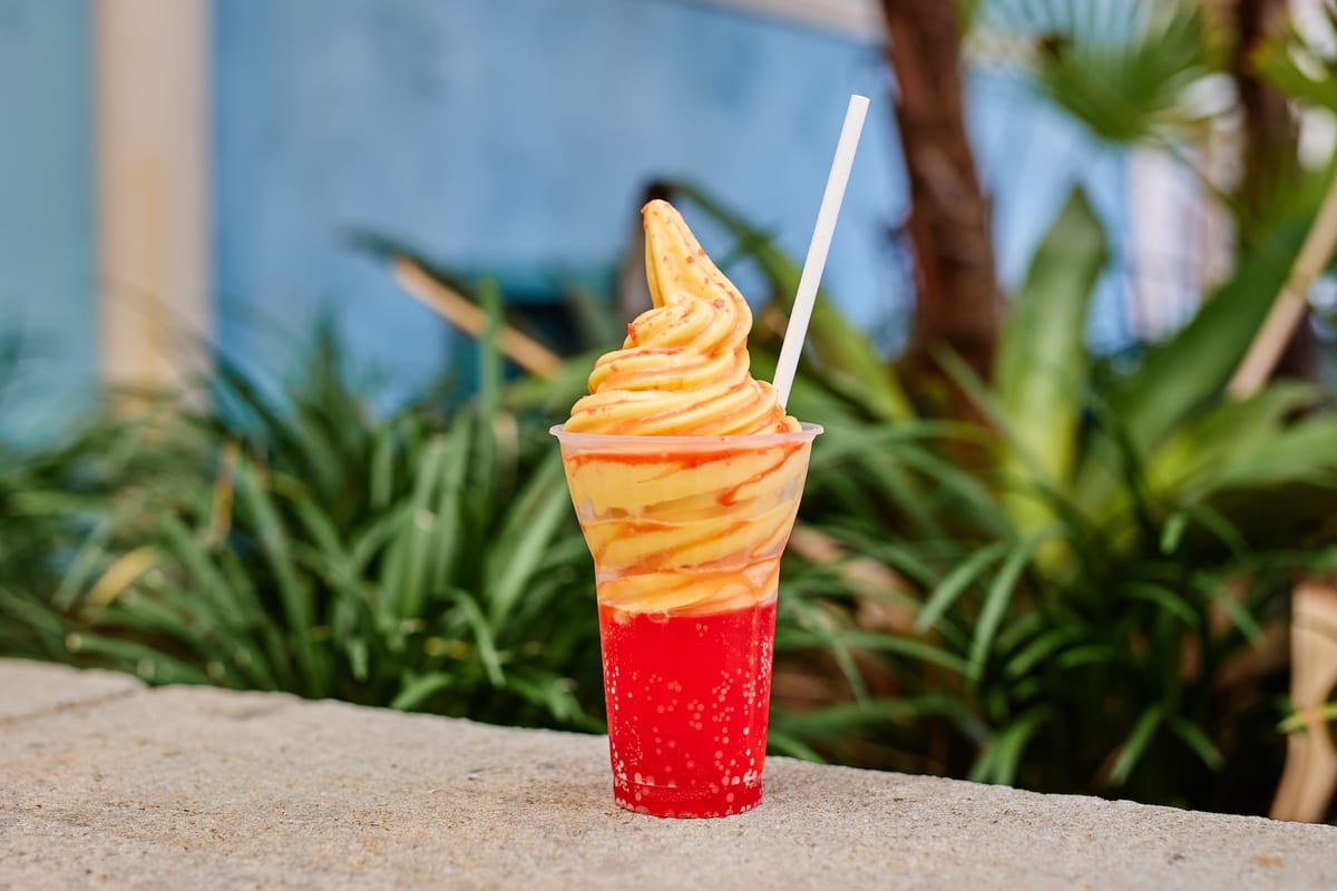 The I Lava You Float at Sunshine Tree Terrace, orange Dole Whip over strawberry and passion fruit soda with popping candy