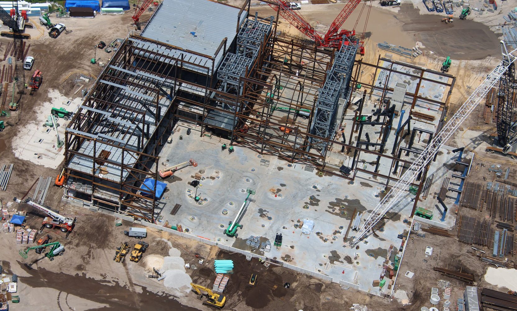 The Monsters, Inc. Coaster's Two Vertical Lift Towers Are Standing, and Dozens of Track Pieces Are Staged Along the Skyliner Route