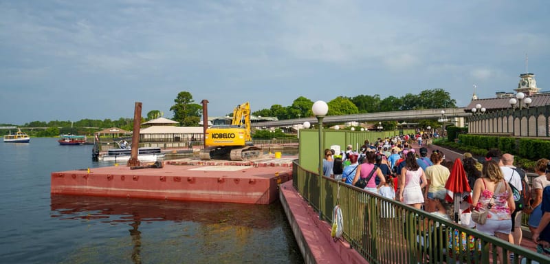A Construction Barge and Excavator Are Now Parked in the Seven Seas Lagoon as Magic Kingdom’s Ferryboat Dock Project Moves Into the Water