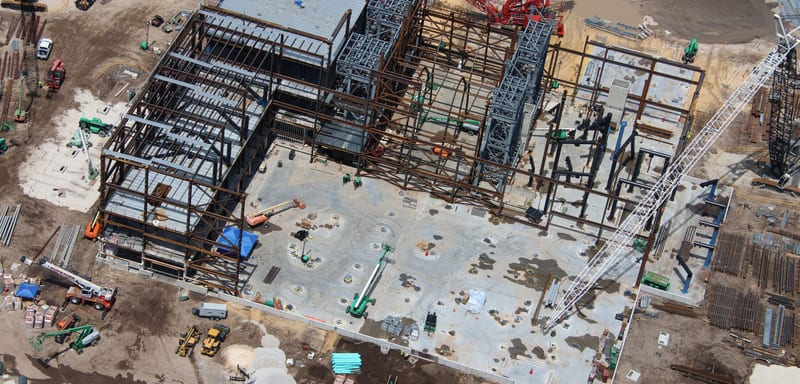 The Monsters, Inc. Coaster's Two Vertical Lift Towers Are Standing, and Dozens of Track Pieces Are Staged Along the Skyliner Route