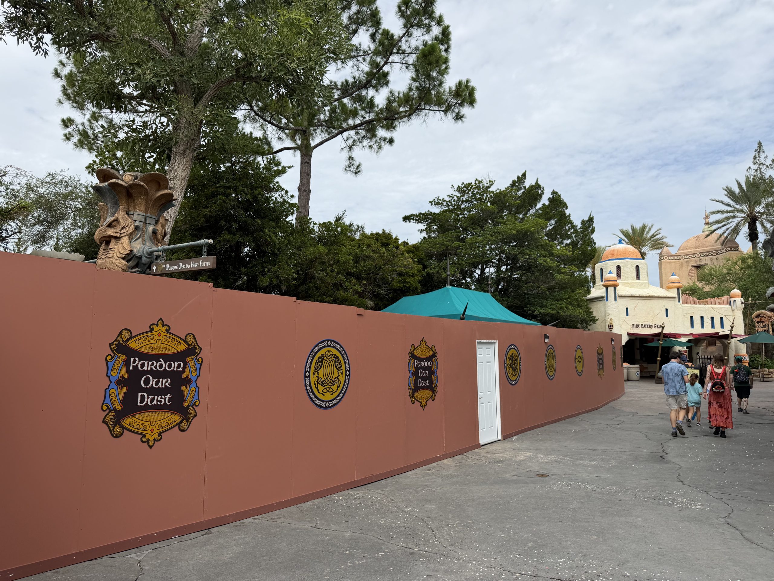 A long run of construction walls in The Lost Continent, with Fire Eater's Grill still open beyond