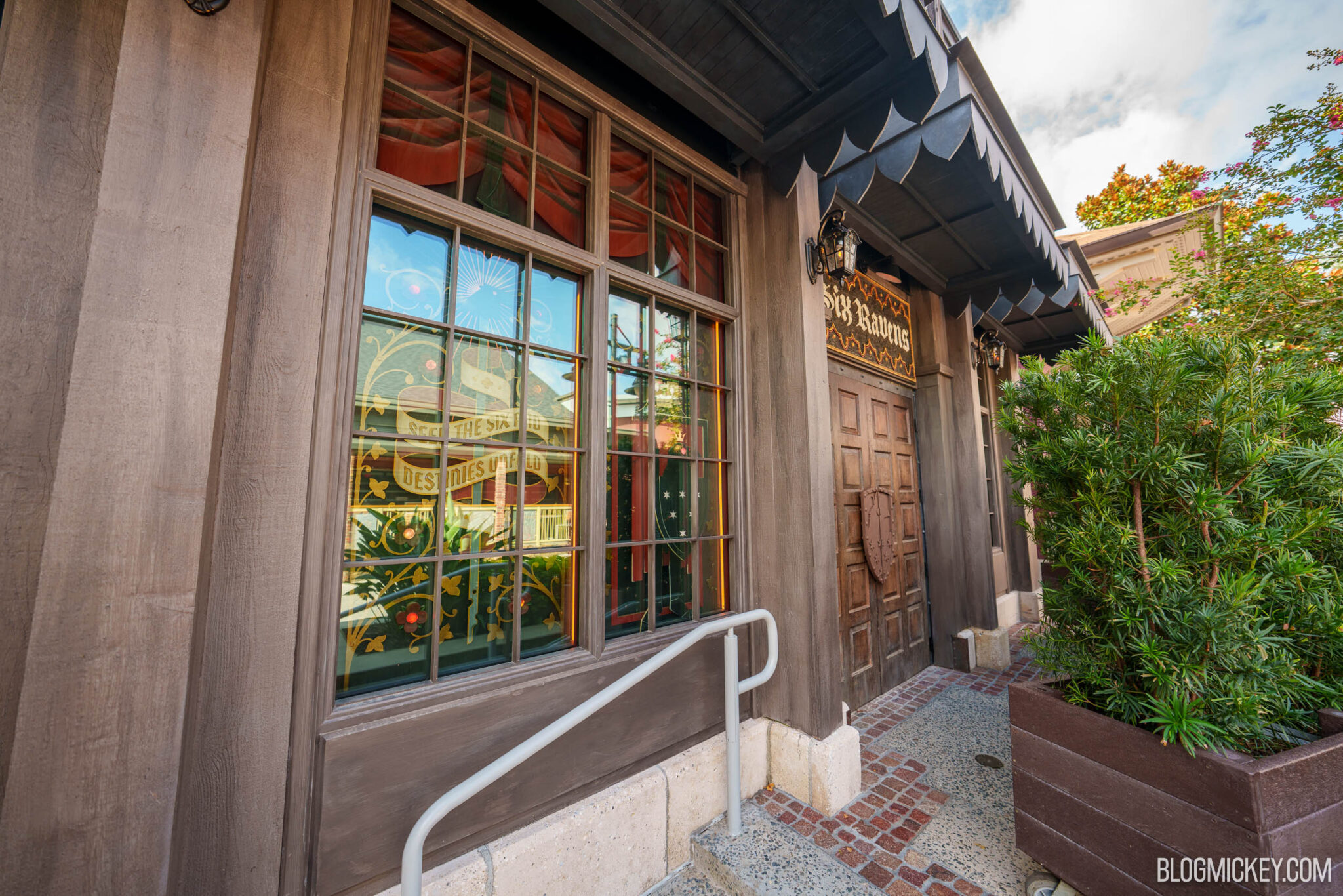 The closed wooden doors and gothic signage at the Six Ravens entrance at Disney Springs