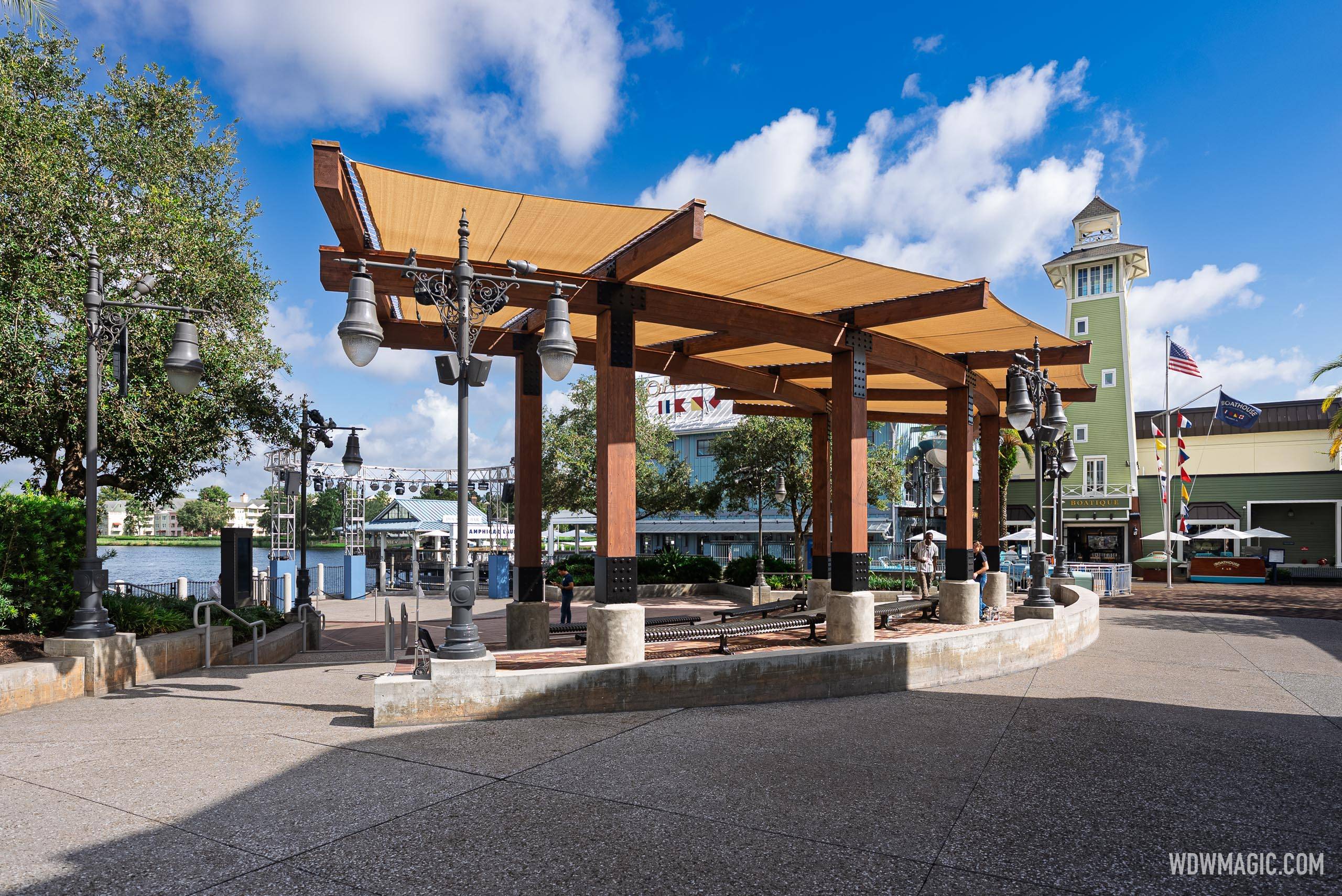 Waterview Park at Disney Springs reopened with a tan shade canopy on dark wood beams, with The BOATHOUSE tower rising beyond it to the right