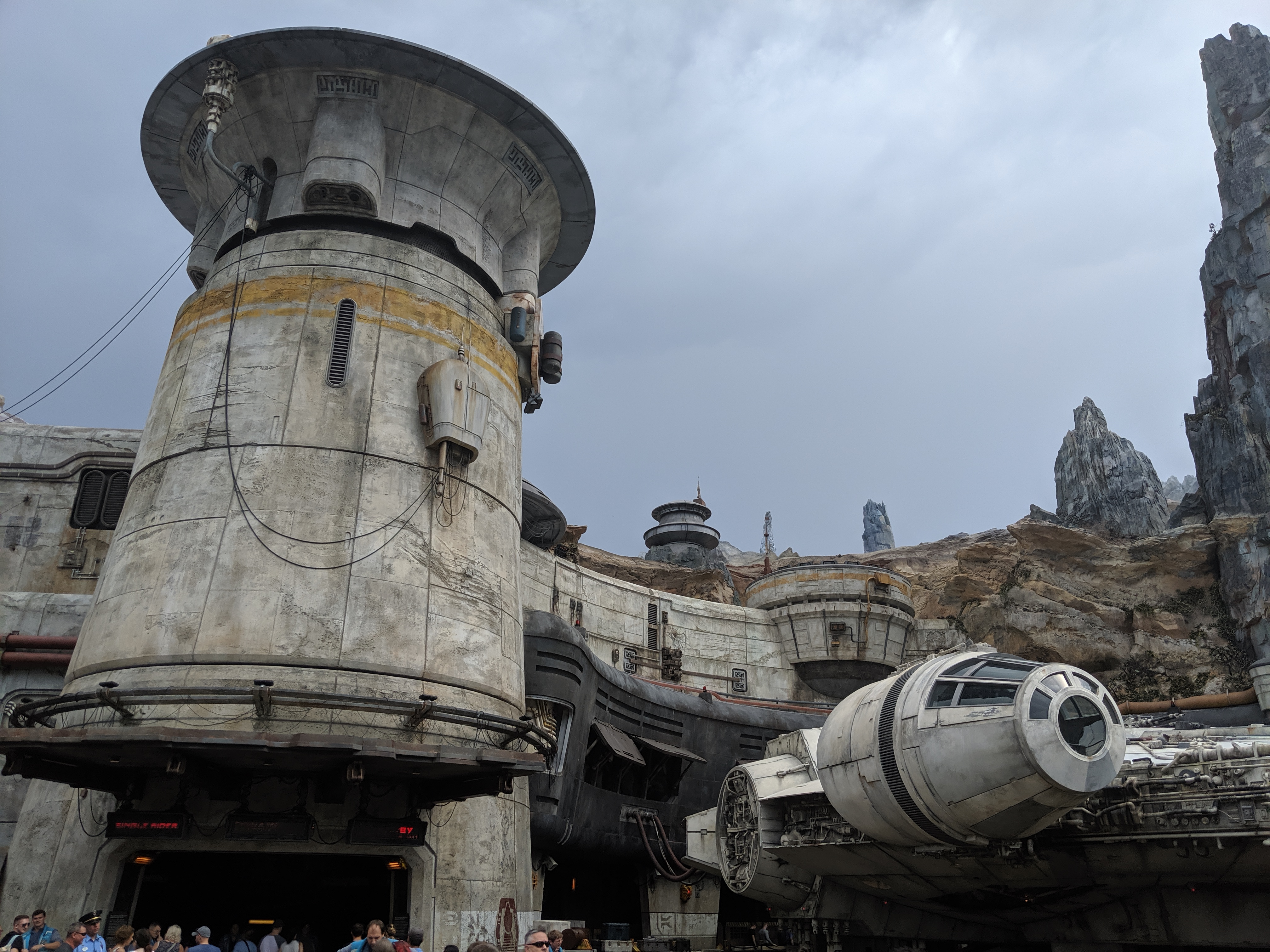 The Millennium Falcon parked outside the Smugglers Run attraction building at Star Wars: Galaxy's Edge