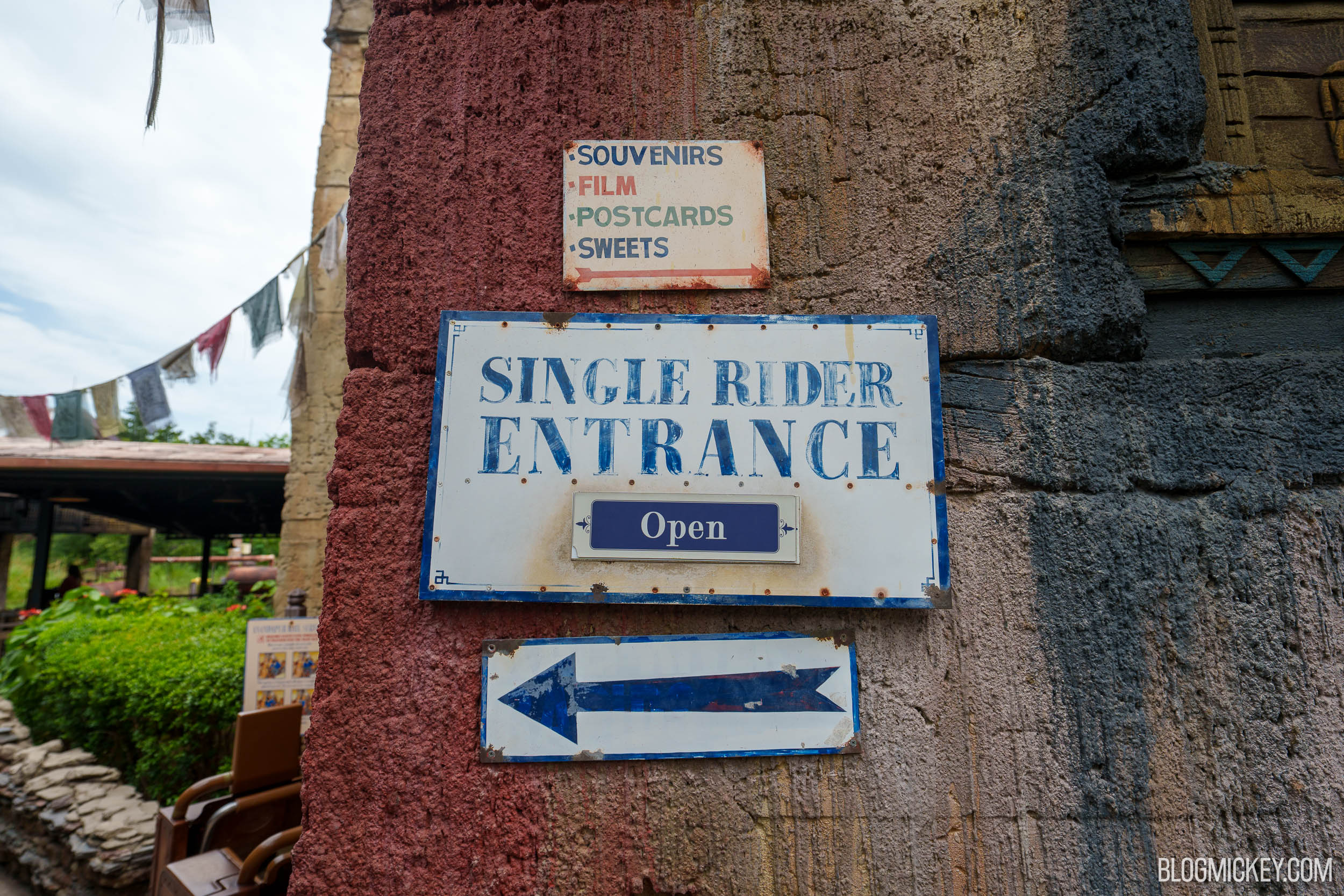 The painted Single Rider Entrance sign at Expedition Everest with a smaller blue placard reading Open