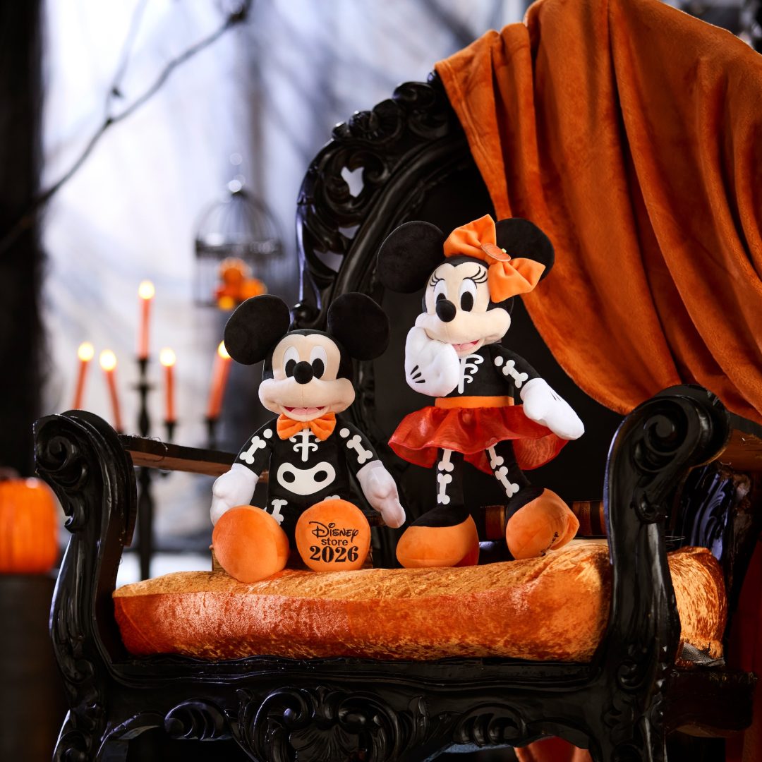 Mickey and Minnie plush in skeleton costumes with an orange Disney Store 2026 pumpkin