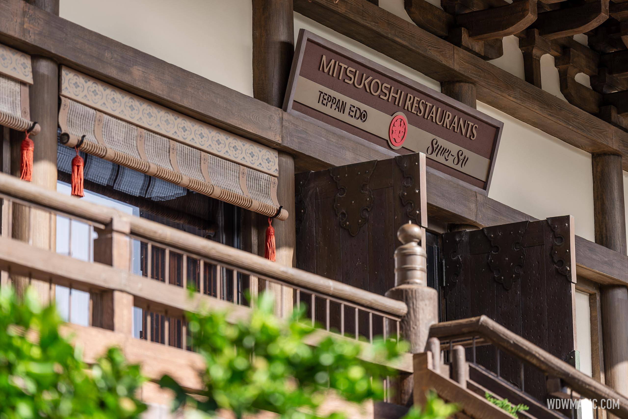 Wooden sign reading MITSUKOSHI RESTAURANTS with TEPPAN EDO and SHIKI-SAI beneath it, mounted above the entrance stairs in the Japan Pavilion