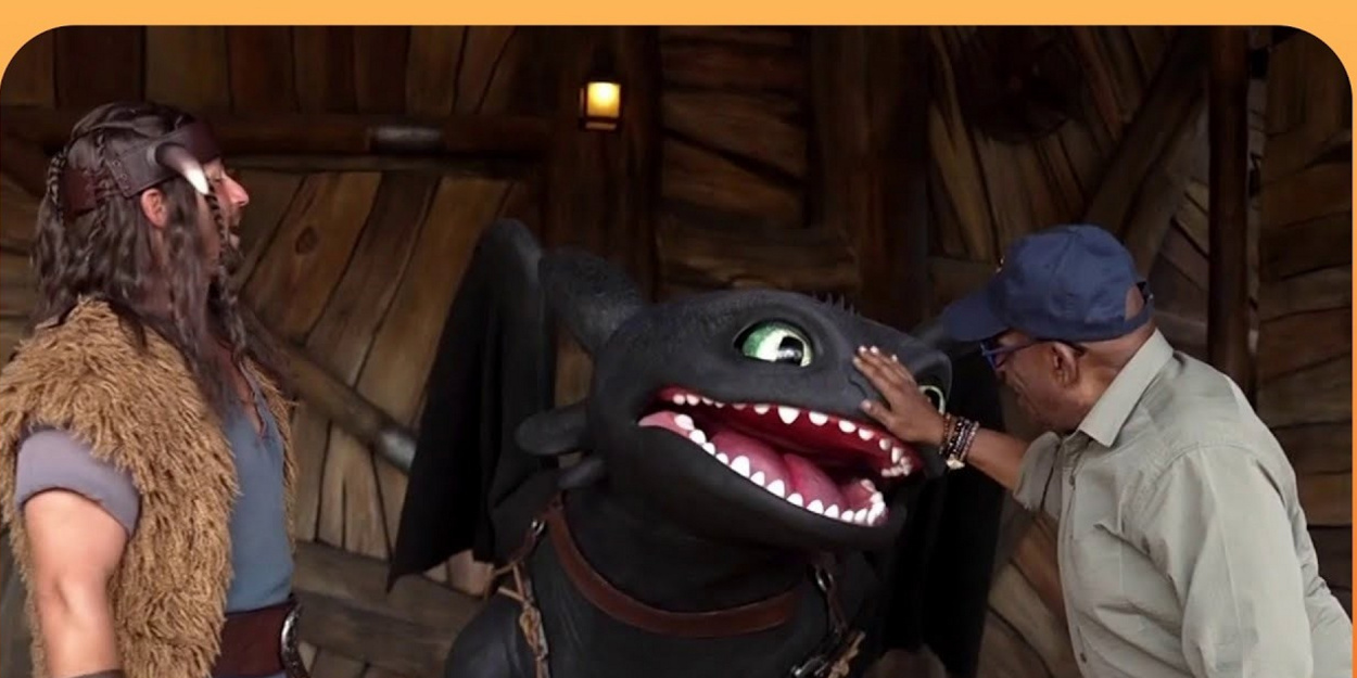 Al Roker in a cap and glasses petting Toothless the dragon on the snout while a costumed Viking character watches