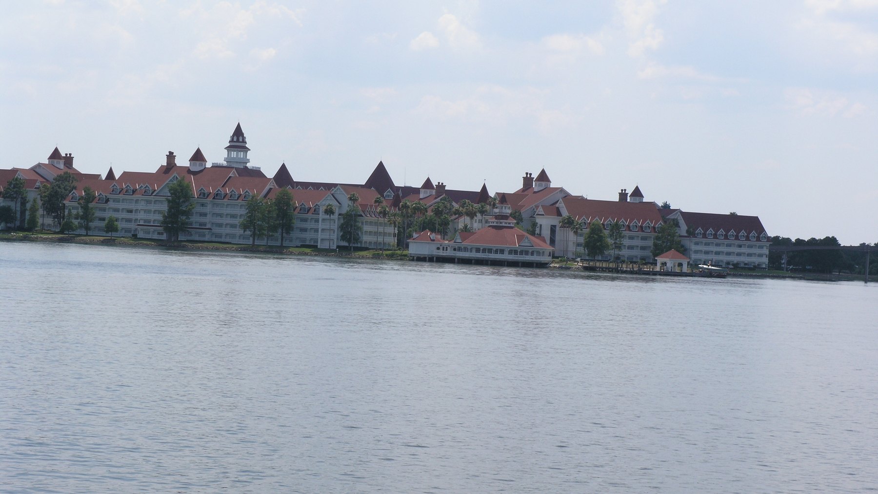 Disney's Grand Floridian Resort and Spa with its red roofs and white Victorian buildings, seen from across the water of Seven Seas Lagoon