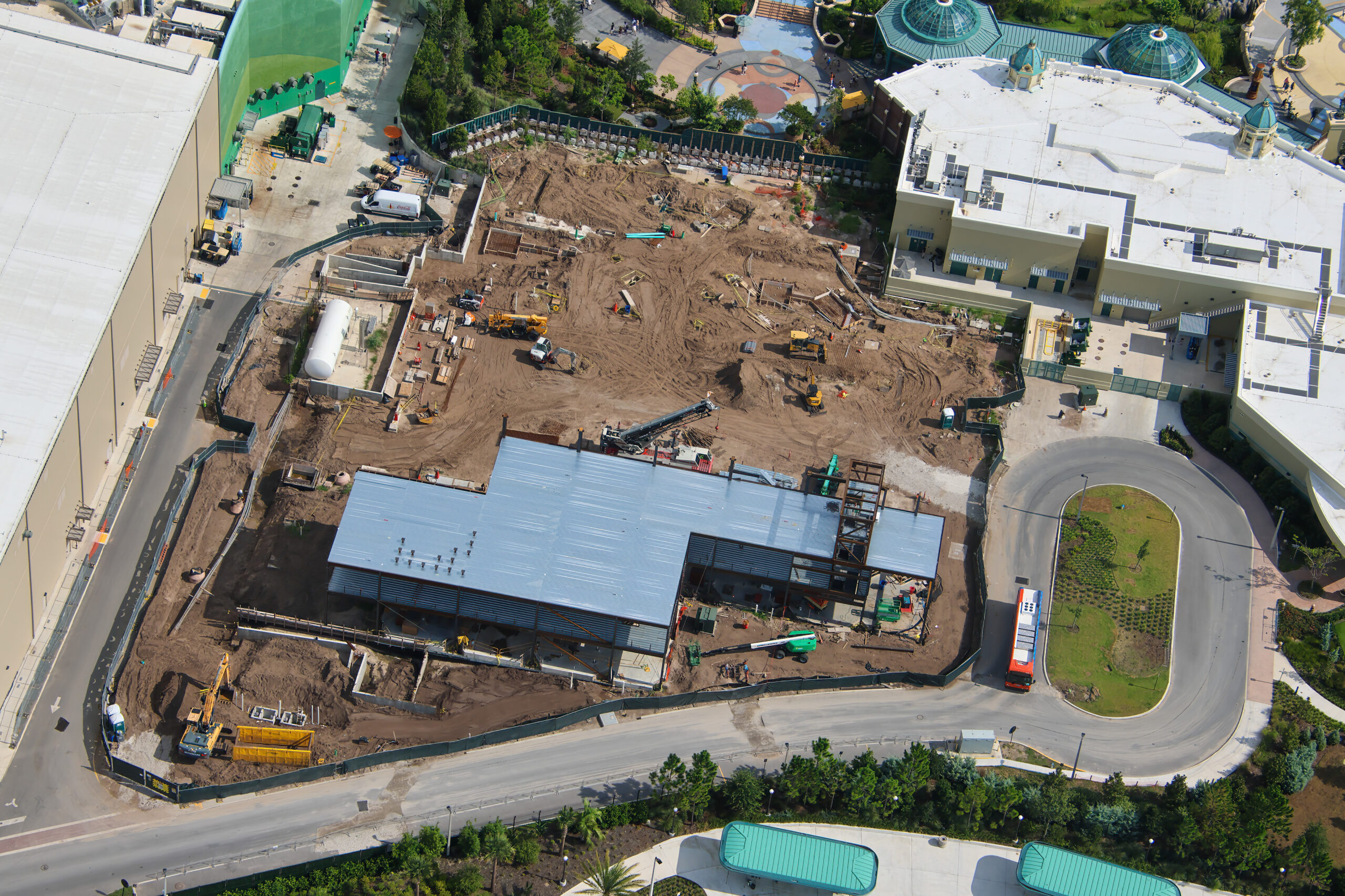 Aerial view of the Epic Universe multipurpose building construction site, with metal decking over its most developed section and bare ground across the rest of the lot