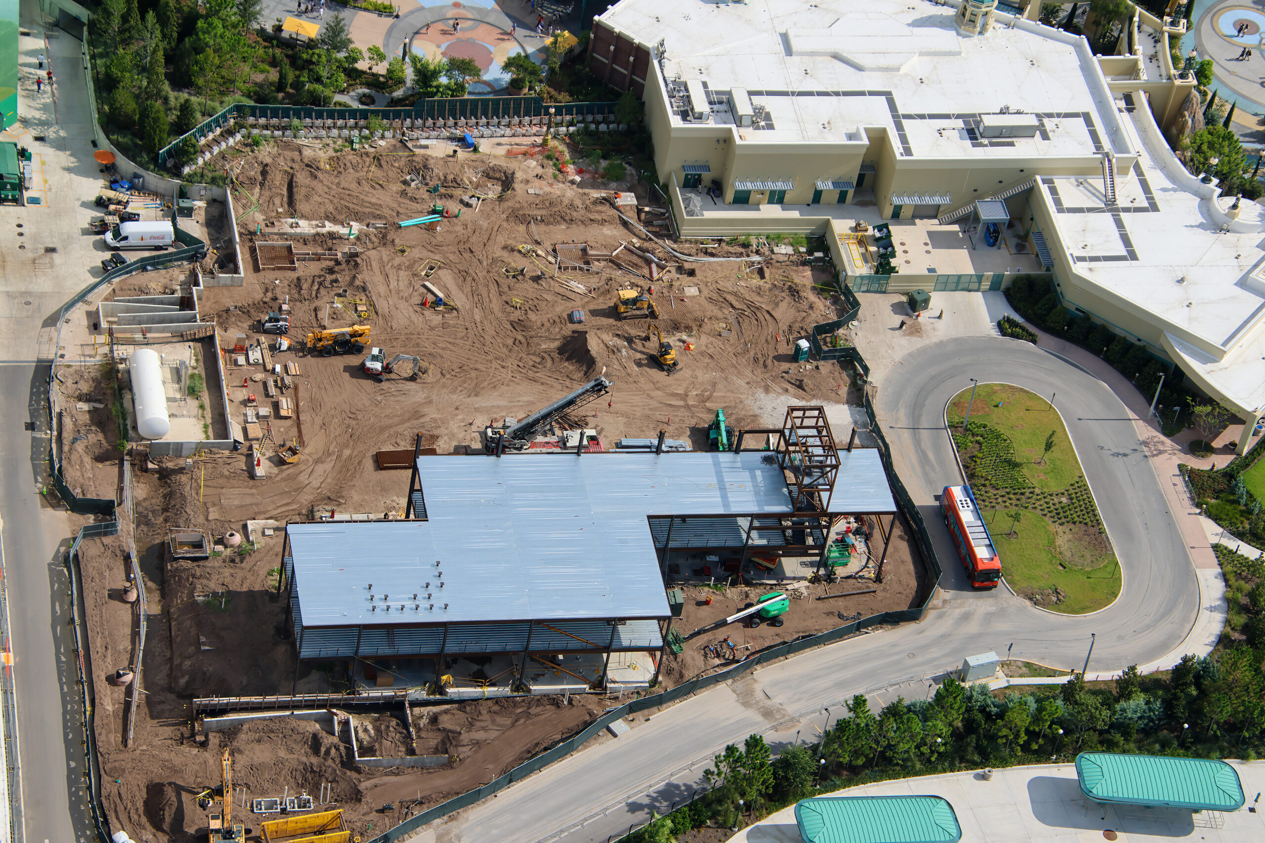 Wide aerial showing the Epic Universe multipurpose building alongside a large area of cleared dirt with excavators, cranes and rectangular foundations