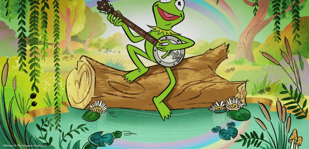 Illustrated Kermit the Frog perched on a log over a lily pad pond, playing a banjo, with a rainbow arcing behind him