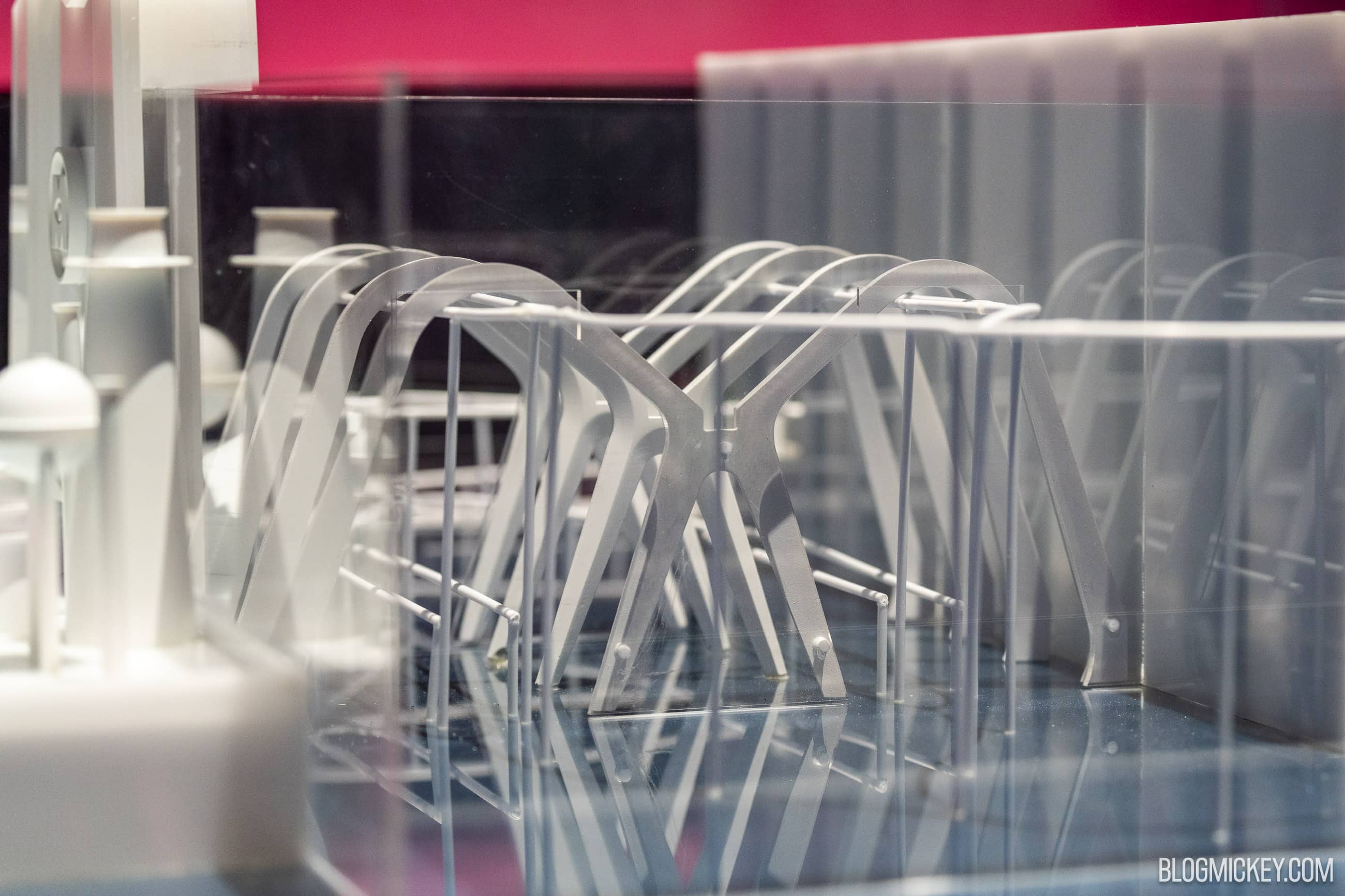 White architectural model of the coaster load station showing a row of arched ribs and a prominent X shaped support at its center