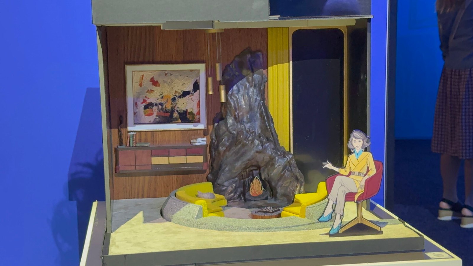 A scale model of the Act 4 future-scene living room with a sunken conversation pit around a rough stone fireplace