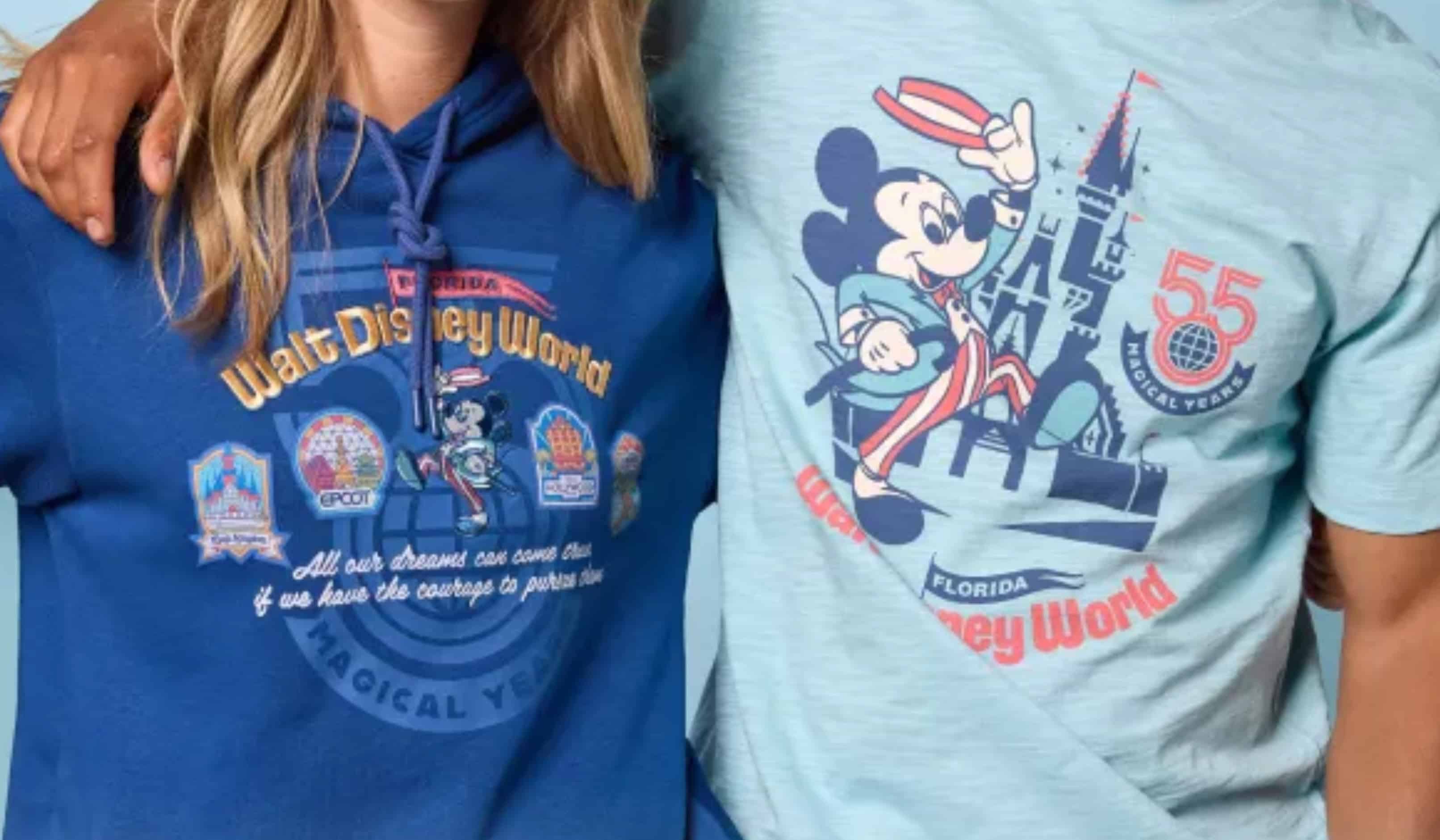 Close crop of two garment chests side by side, the blue hoodie print at left and the light blue tee print at right showing the coral 55 logo over a MAGICAL YEARS banner.