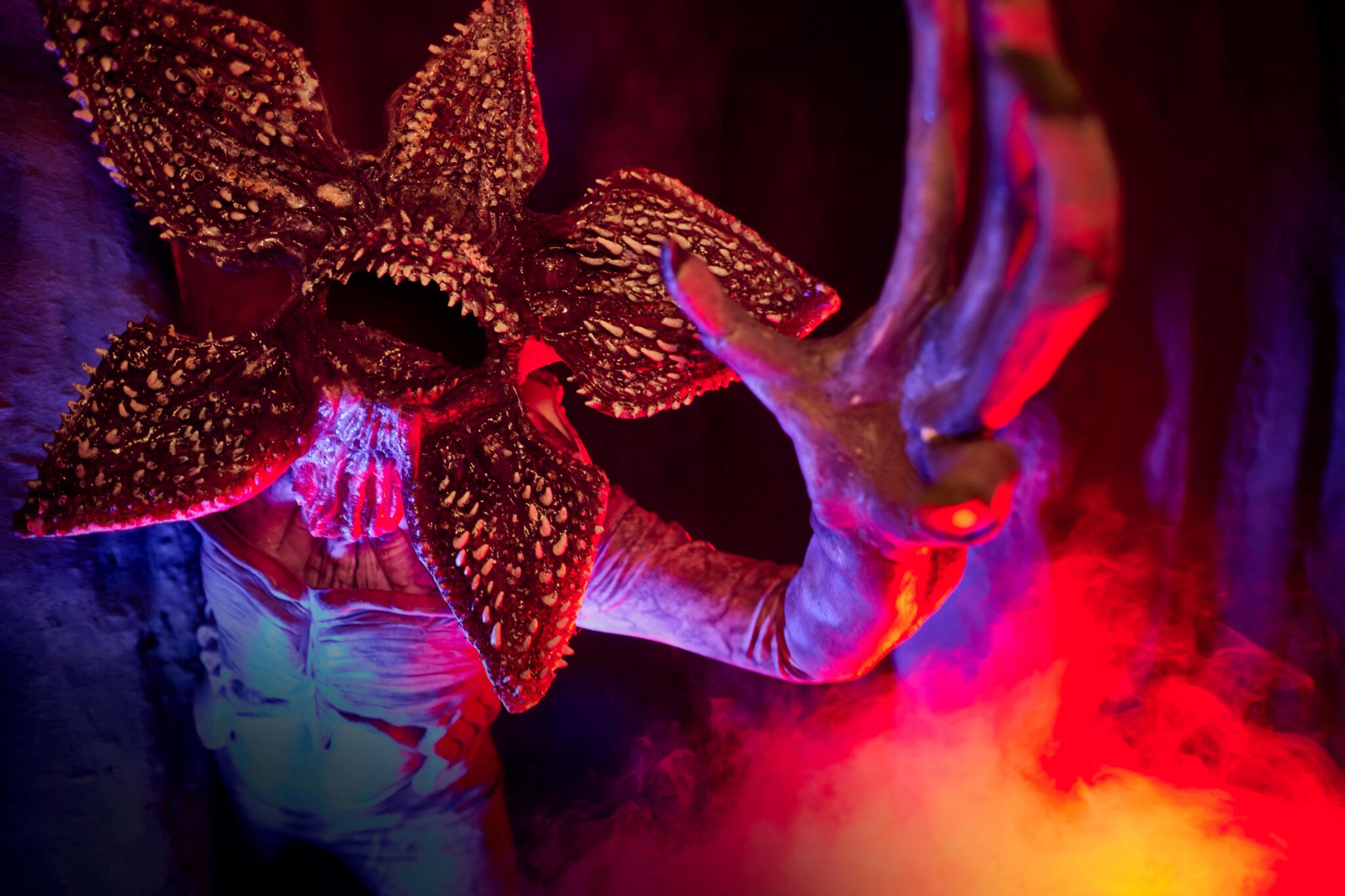 A Demogorgon with its face splayed open, from Universal's press image for the Stranger Things 5 haunted house at Halloween Horror Nights 35