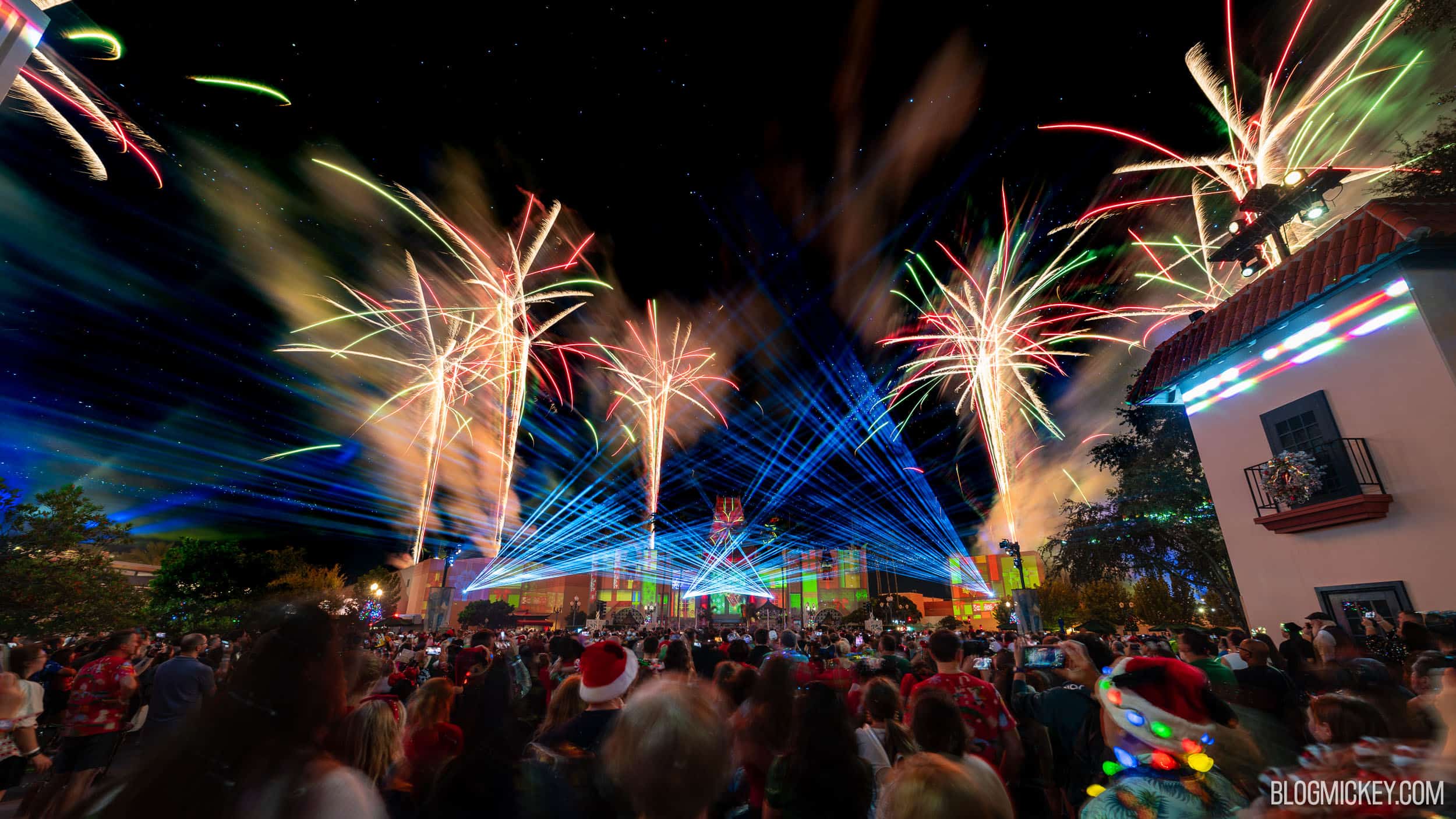 Red, green and gold fireworks and blue lasers over the Chinese Theater at Disney's Hollywood Studios during Jingle Bell, Jingle BAM!