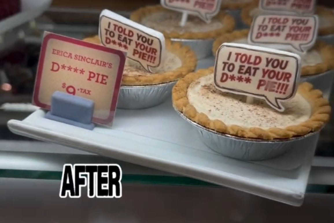Mini pies in foil tins in a bakery case, each topped with a fondant speech bubble reading I told you to eat your D*** pie with asterisks, beside a red bordered price card reading Erica Sinclair's D**** pie, 9 dollars plus tax, with the word AFTER added in large letters at the bottom