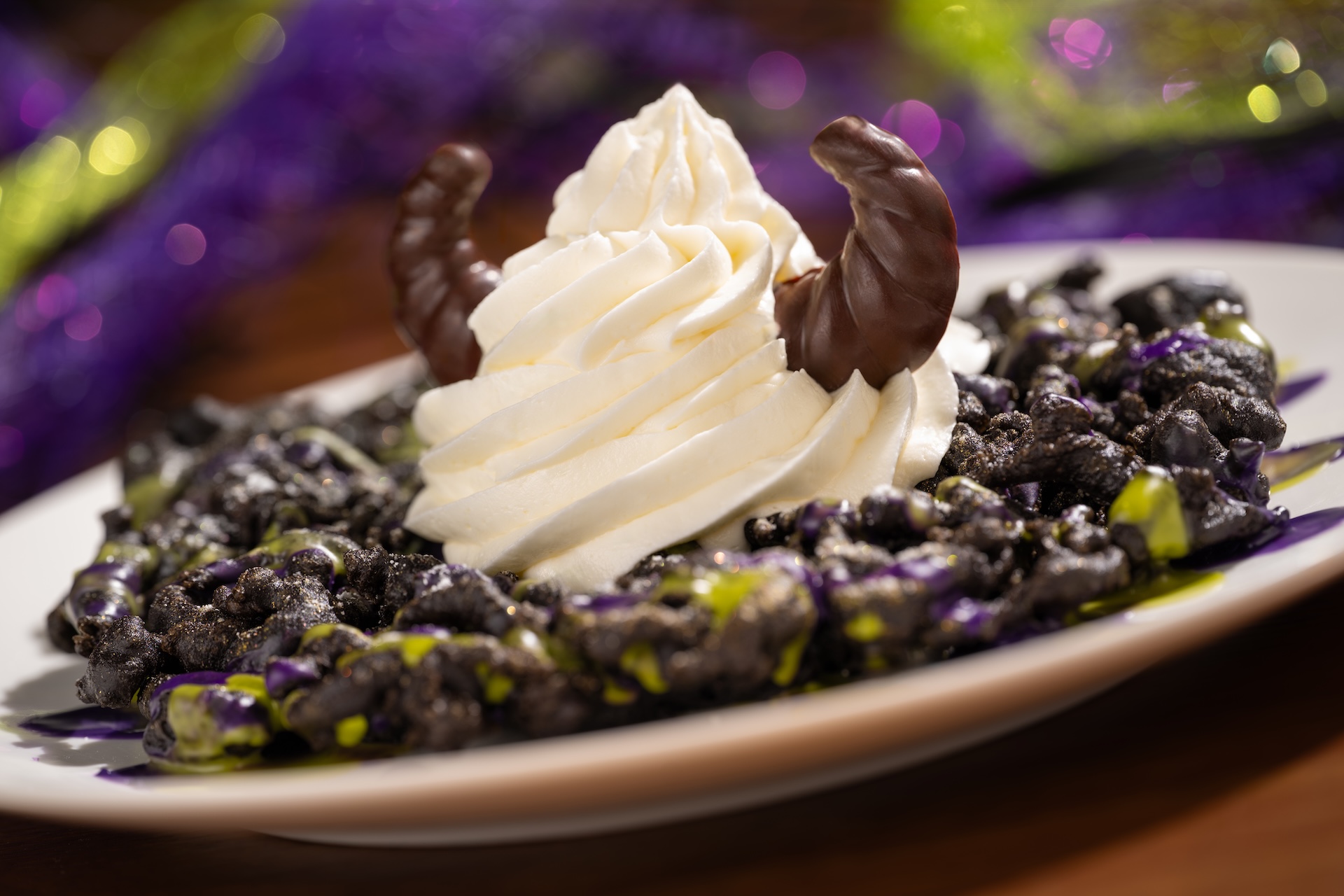 Maleficent Funnel Cake, a chocolate funnel cake with purple and green icing, soft serve and chocolate horns