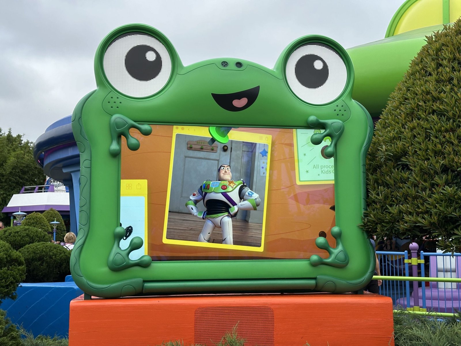 Lilypad's frog-shaped screen showing a clip of Buzz Lightyear standing on a wooden floor in front of a white door