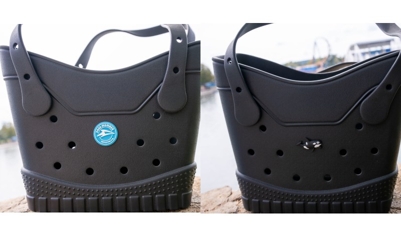 Side-by-side photos of a black rubber tote bag, one with a round blue Pass Member charm and the other with a small orca charm
