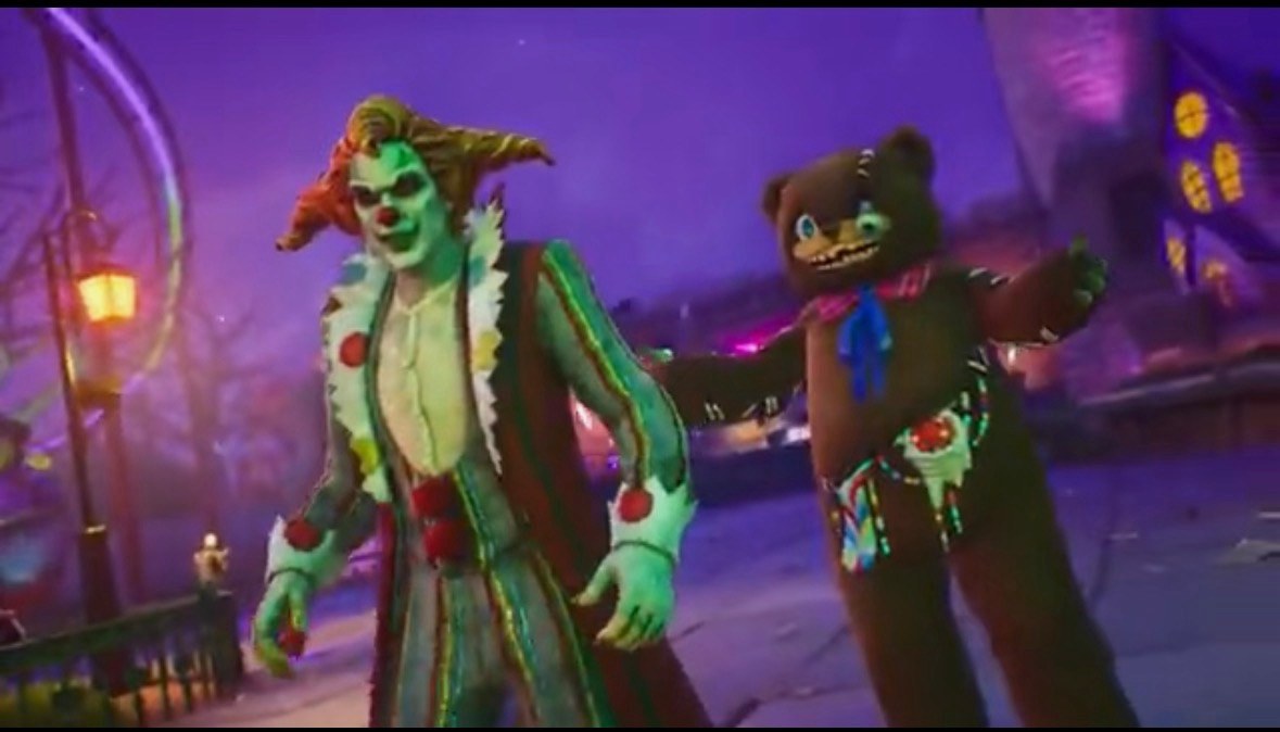 In-game Fortnite versions of Jack the Clown, with a green face, swept red hair and a polka-dot collar, and a brown teddy bear with stitched seams and a blue bow, on a purple-lit carnival street beside a Ferris wheel