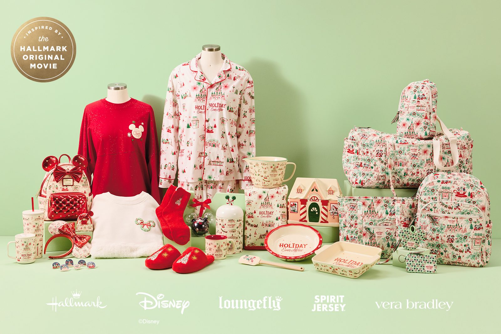 Holiday Ever After merchandise on a mint green backdrop, including a red Spirit Jersey, castle-print pajamas, a Minnie ears Loungefly mini backpack with a red bow, Vera Bradley quilted bags, Corkcicle tumblers, bakeware and slippers, with Hallmark, Disney, Loungefly, Spirit Jersey and Vera Bradley logos