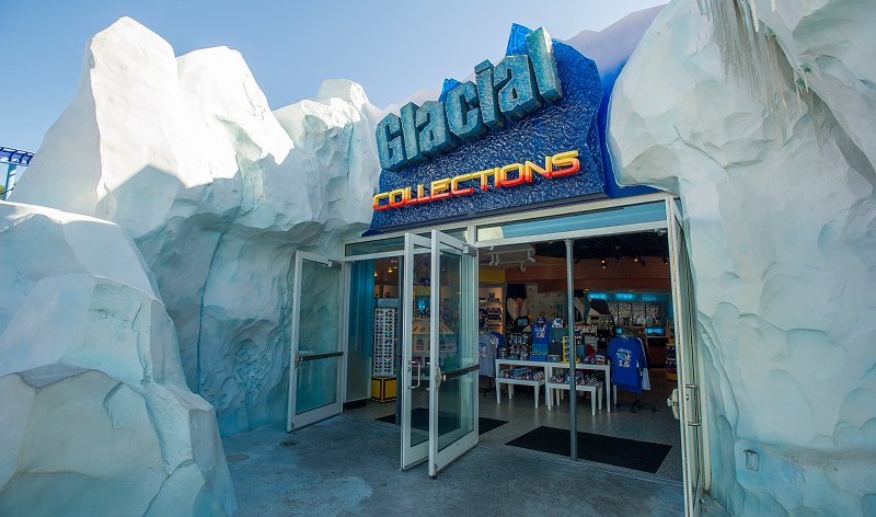 The entrance to the Glacial Collections shop at SeaWorld Orlando, set into white faux-ice rockwork under a blue Glacial Collections sign