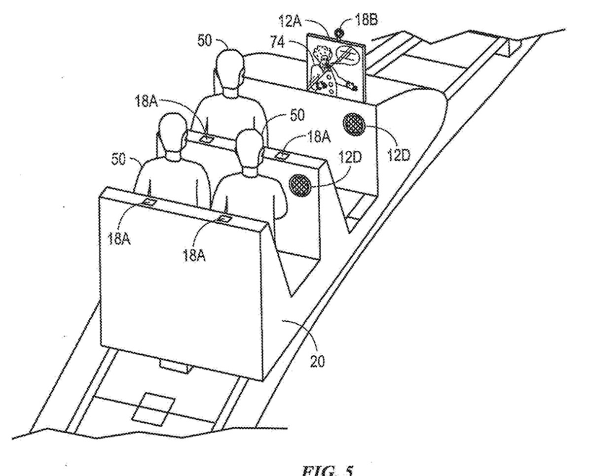 Patent drawing of three riders seated in a ride vehicle on a track, with a screen and camera on the front of the vehicle and round speakers on its sides