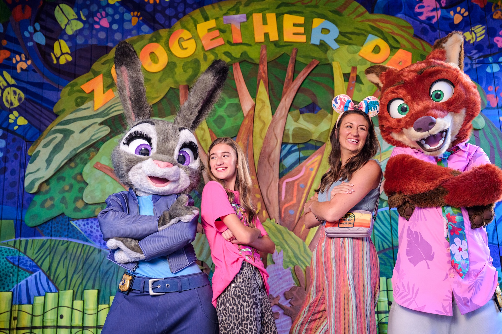 Two guests posing with Judy Hopps and Nick Wilde at a Zootopia character greeting at Disney's Animal Kingdom