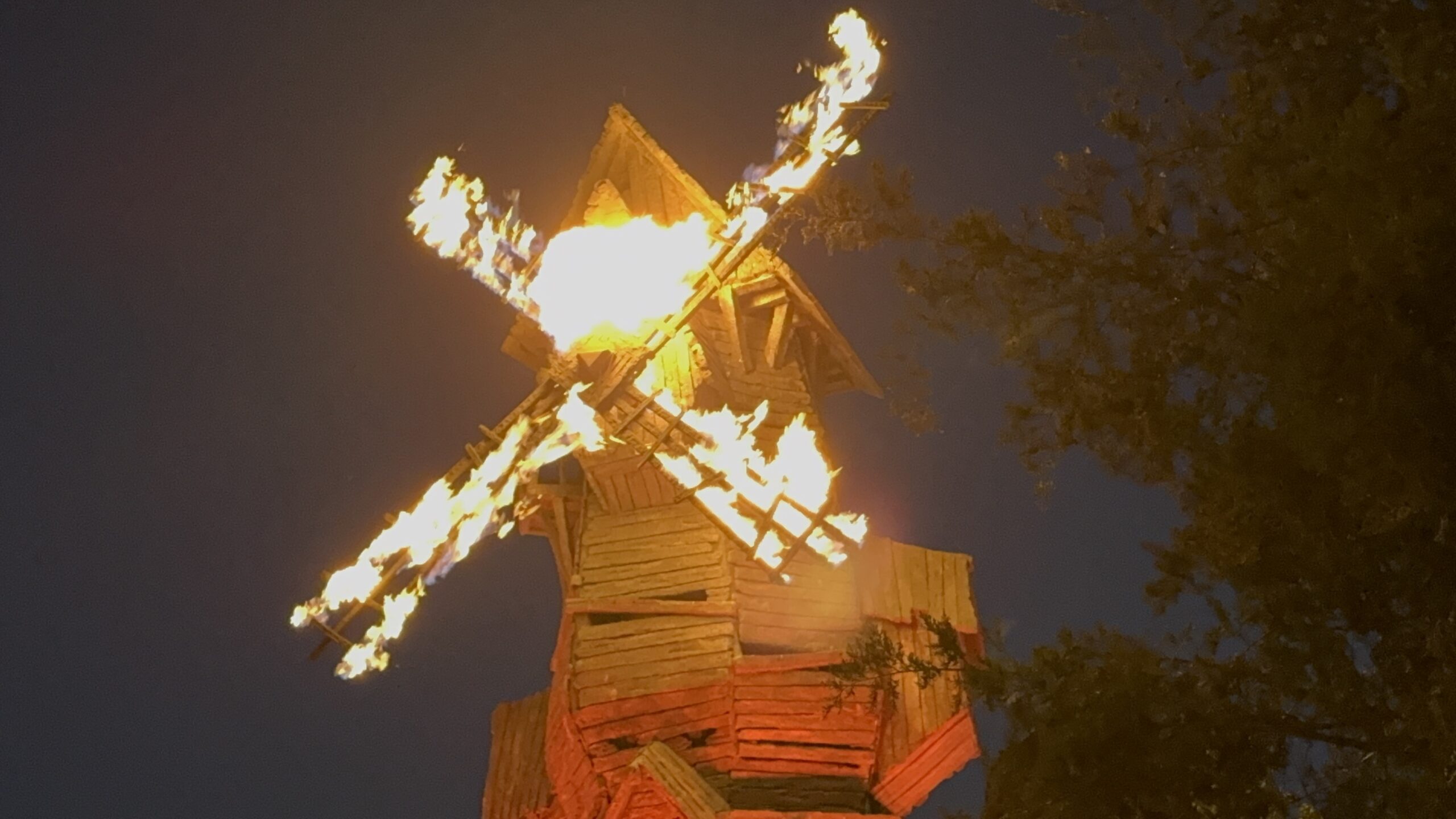 A burning windmill prop lights up Darkmoor Village at night in Dark Universe.