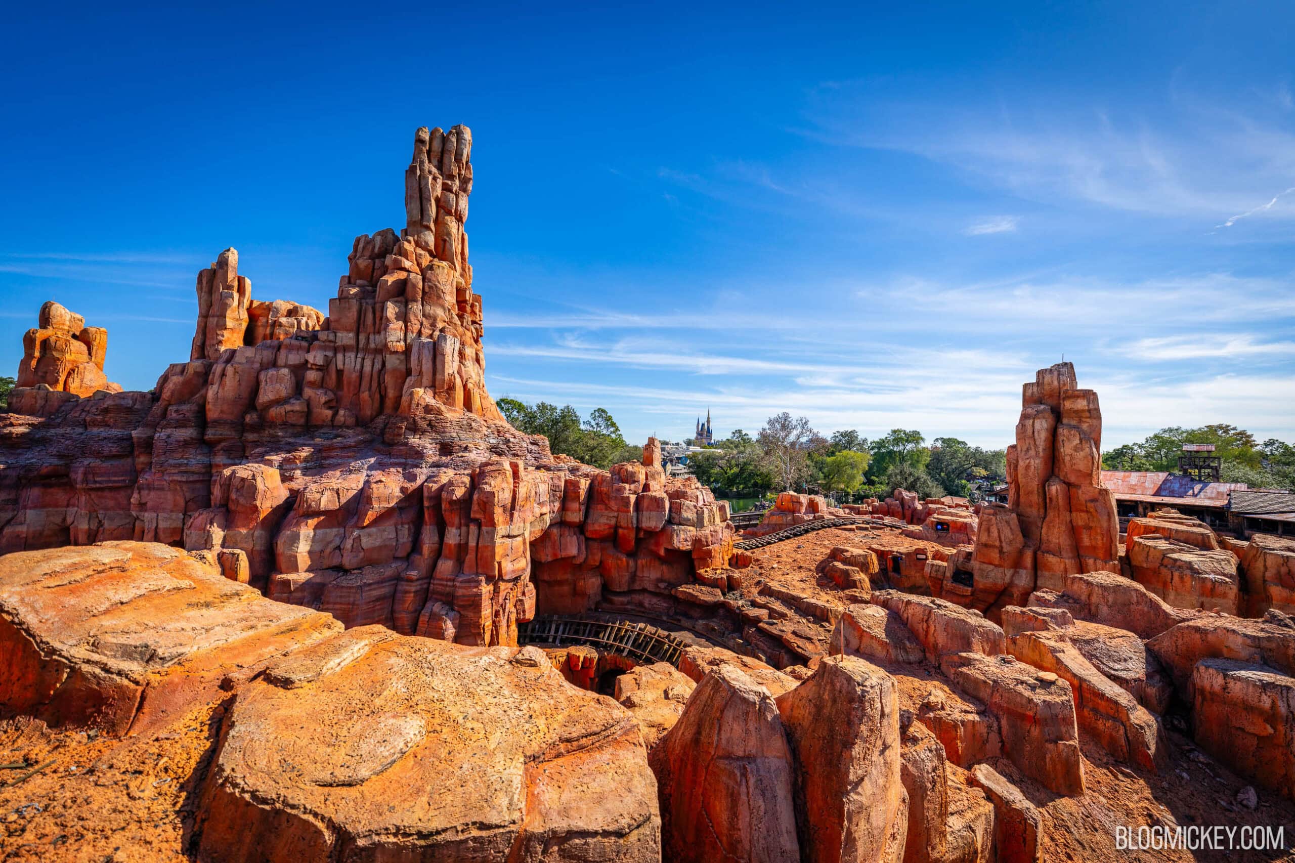 On-ride photo of a Big Thunder Mountain Railroad mine train rounding a red rock curve