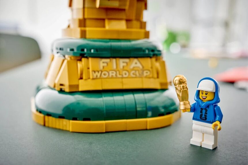 A LEGO-built FIFA World Cup trophy on display at Legoland Florida, photographed in a soft-lit setting that highlights the gold brick construction.