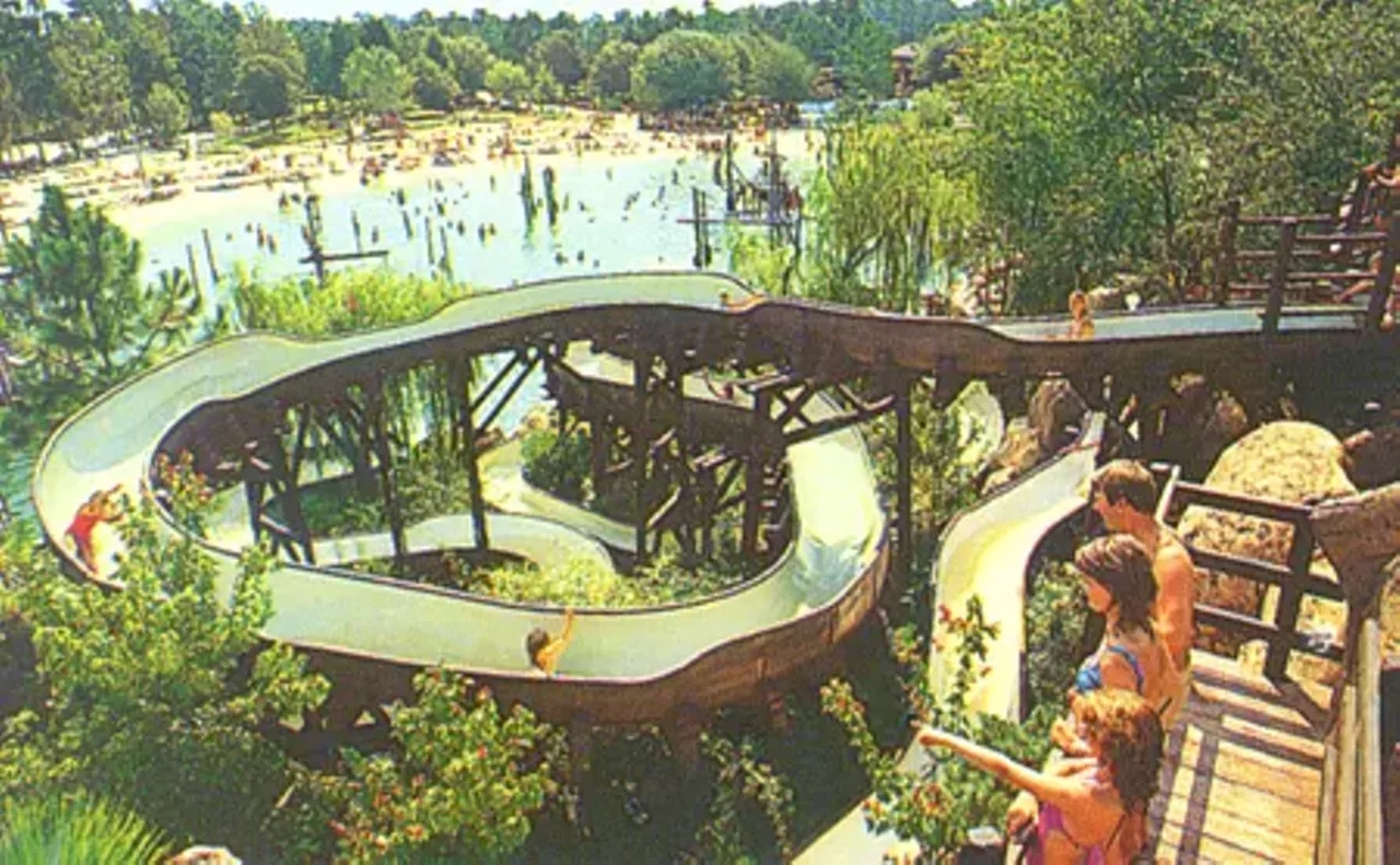The abandoned Whoop n Holler Hollow slide tower at Disney's River Country, overgrown with vegetation years after closure