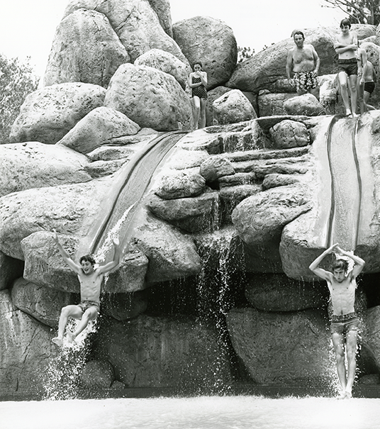 Guests ride the Slippery Slide Falls water slides into Upstream Plunge at Disney's River Country