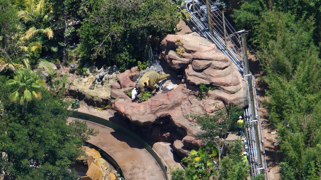 Aerial photo of the baby Stegosaurus animatronic at Jurassic Park River Adventure during the 2026 refurb, with its face skin removed to upgrade the head's moving elements.