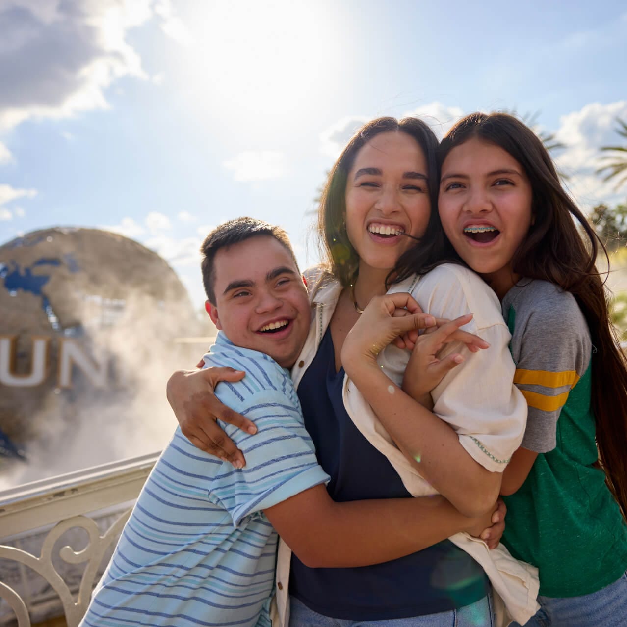 A family in front of the Universal globe at Universal Orlando