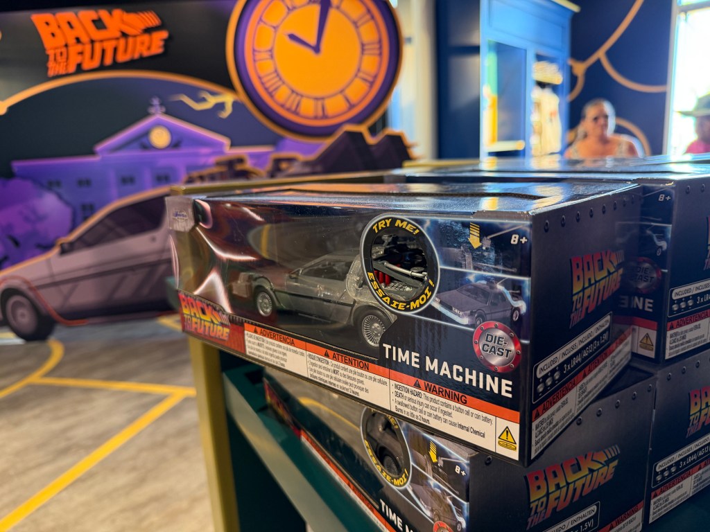 The Back to the Future photo op inside the Universal Legacy Store, featuring the DeLorean parked at the Hill Valley clock tower.