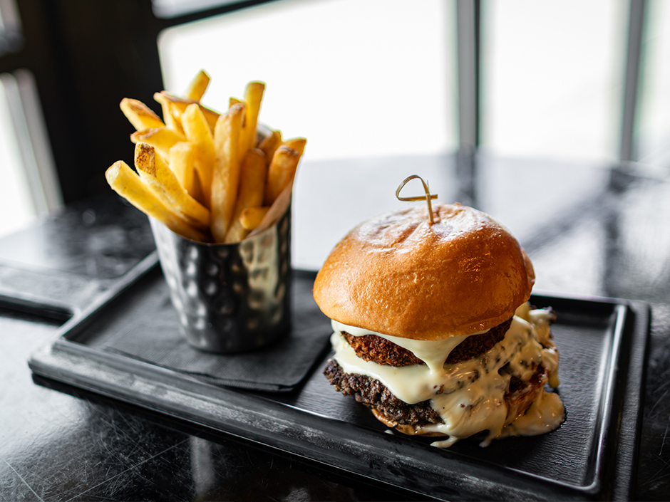 The Mac and Cheeseburger with fries at NBC Sports Grill and Brew in Universal CityWalk